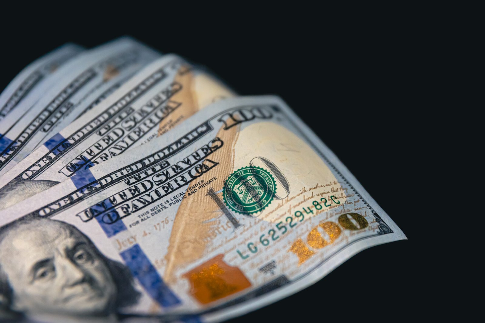 close up, american dollar bills on a black background.